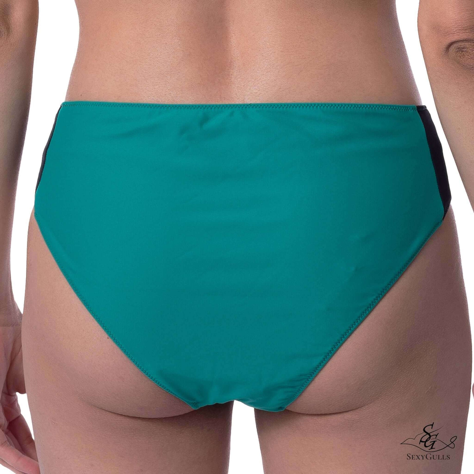 Back view of a woman in two-toned green and black bikini bottom featuring full bum coverage