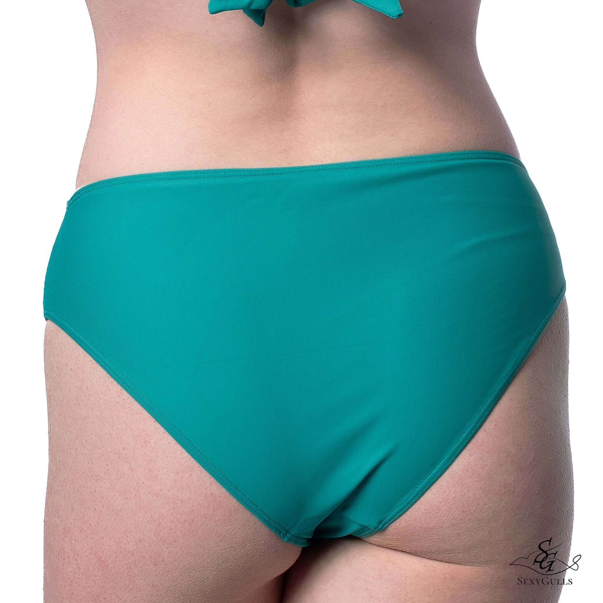 Back view of woman in green full bum coverage bikini bottom.