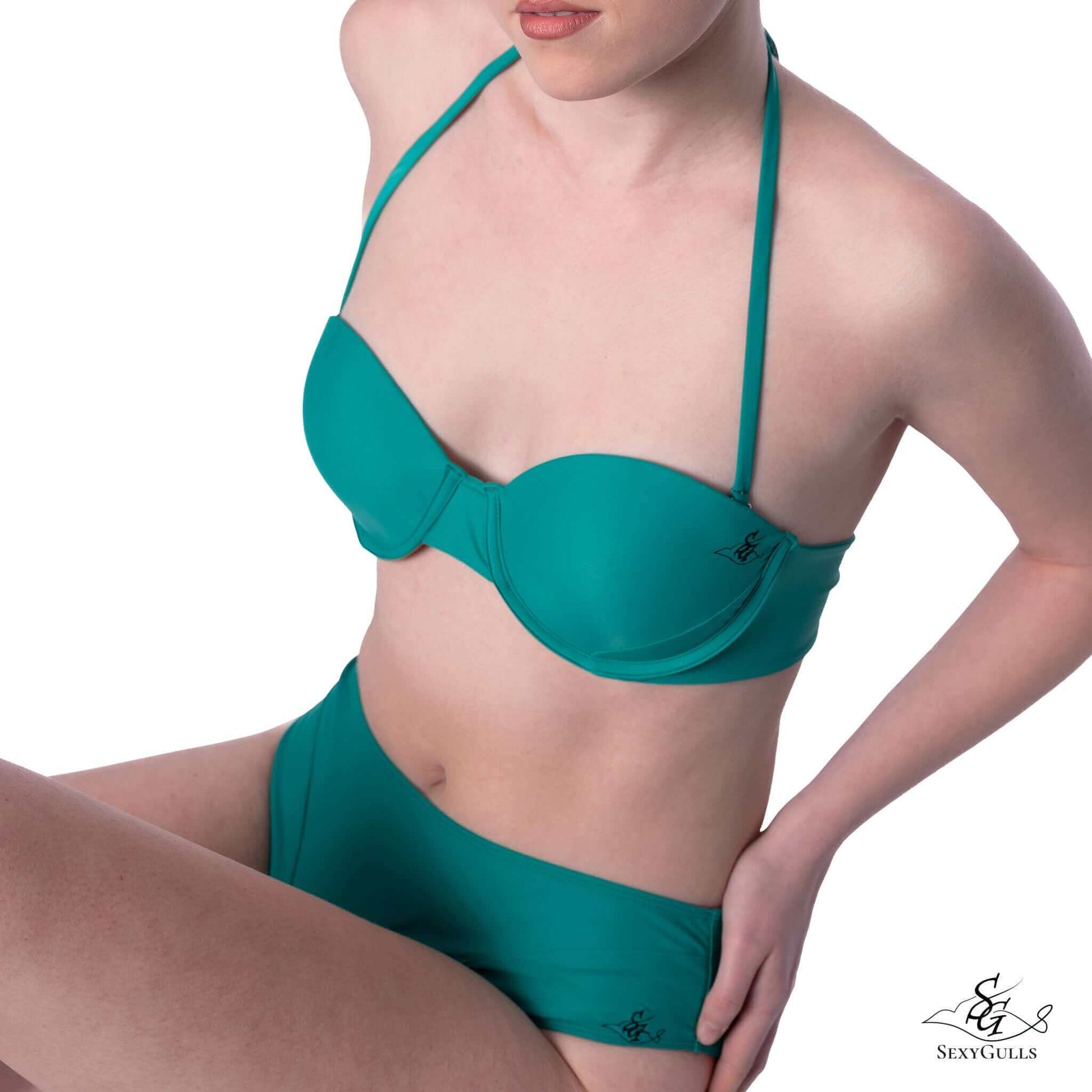 Side view of woman wearing green bikini bottom with matching top, providing a full set reference