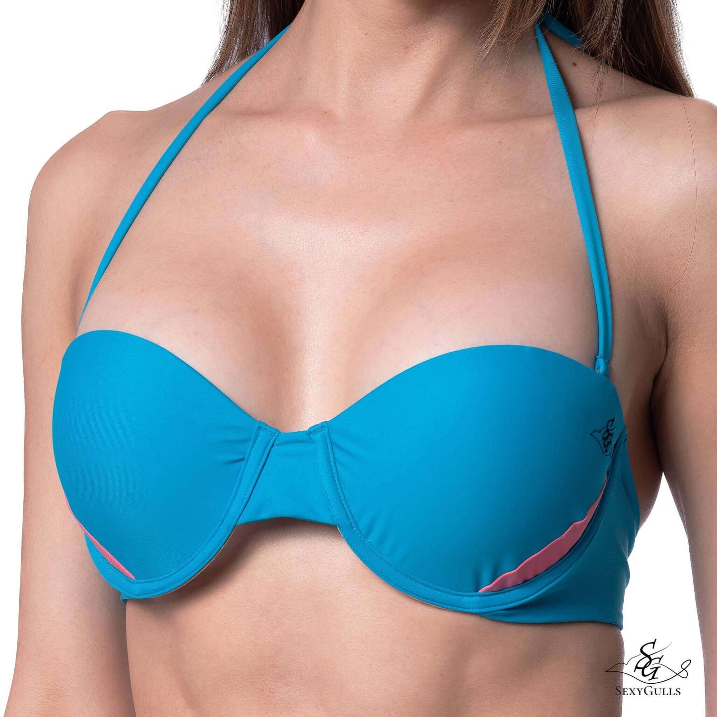 A woman wearing a two-toned pink and blue bandeau bikini top featuring a removable straps, underwire and moulded fuller cups for big bust women