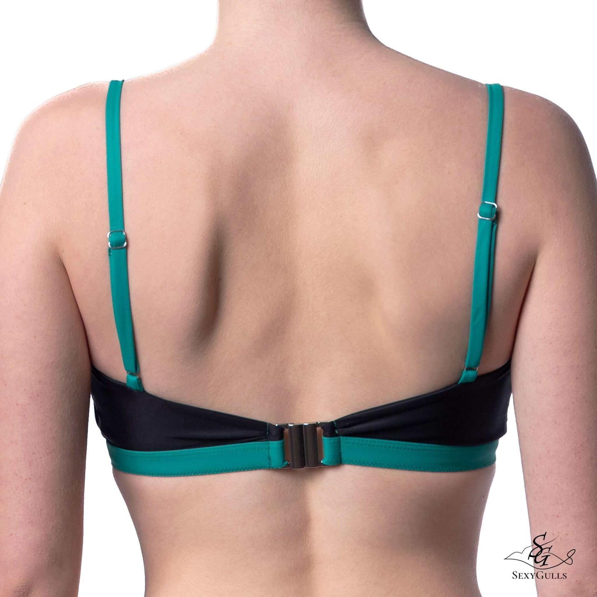 Zoomed in back view of woman in two colours bikini top with metallic clasps and slider buckle.