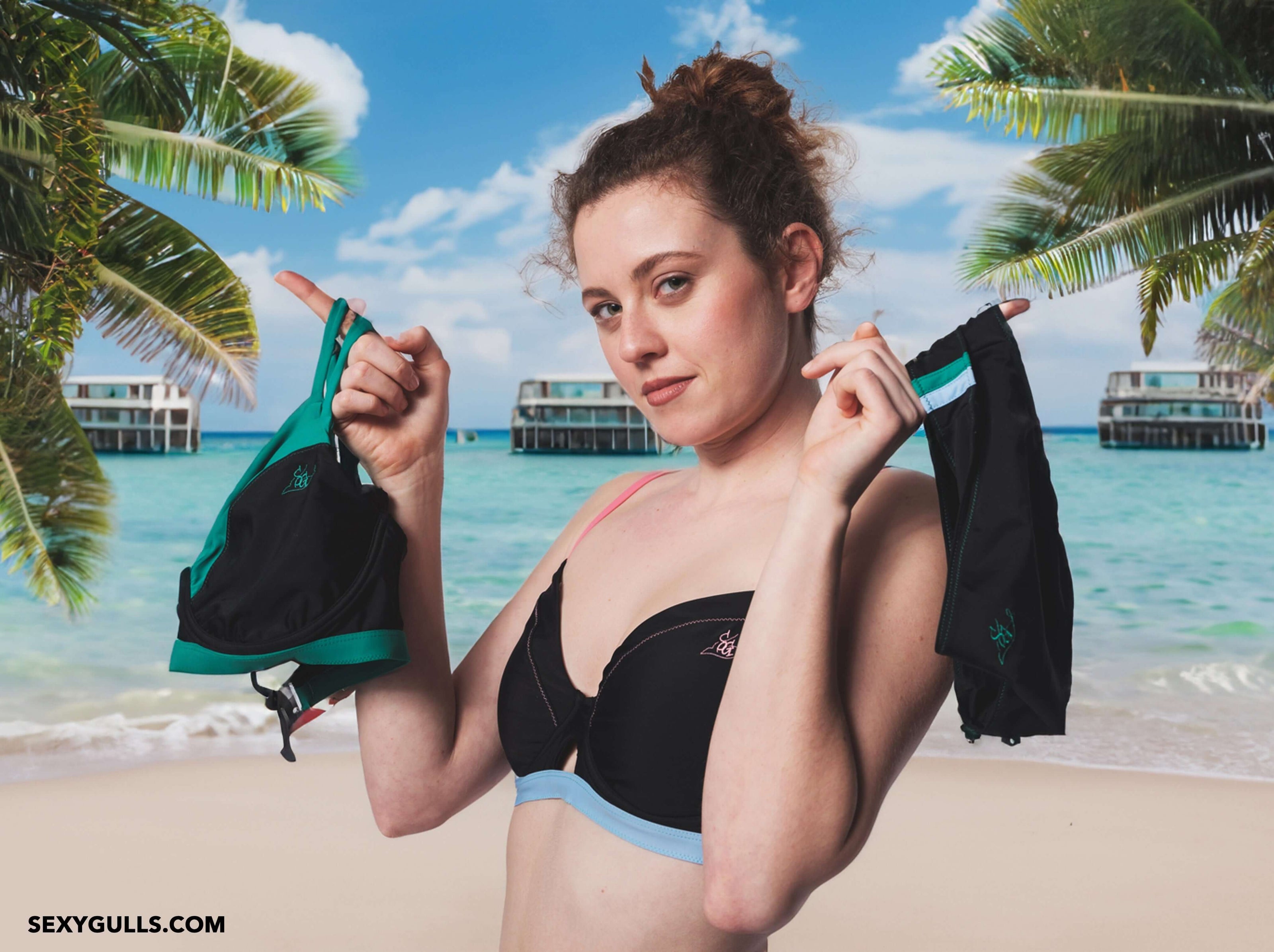 a woman with sexygulls bikini on both of her hands showcasing the swimwear